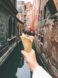 Cropped image of hand holding ice cream cone