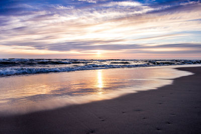 Scenic view of beach against sky during sunset