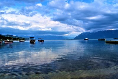 Boats in sea against sky