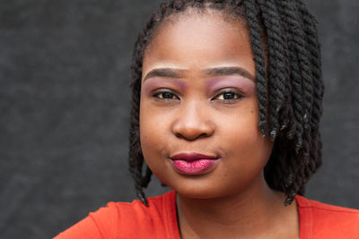 Close-up portrait of young woman with locs