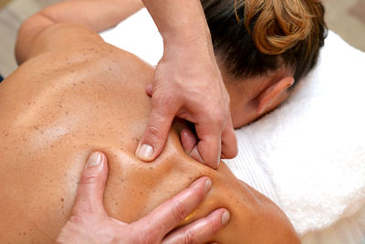 Close-up of hands massaging woman