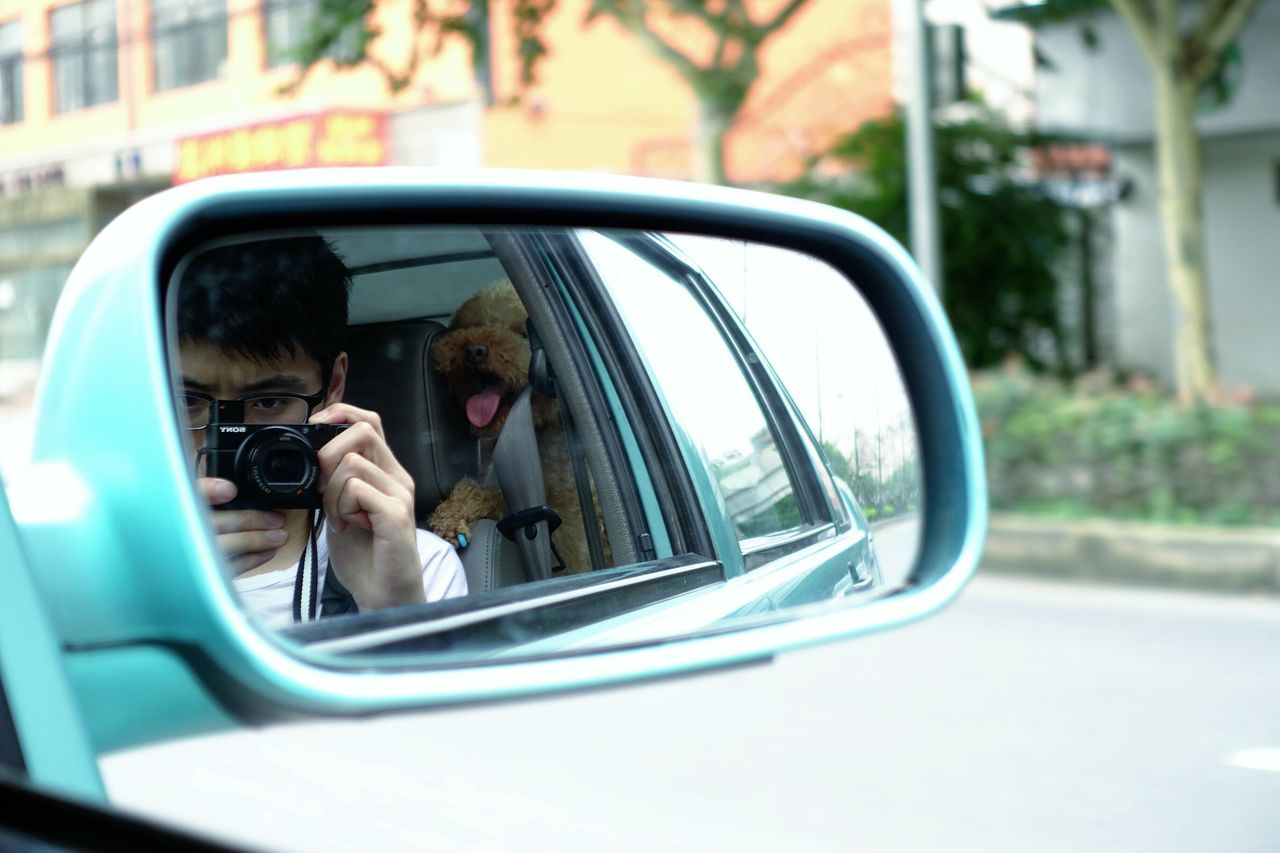 transportation, mode of transport, land vehicle, reflection, car, glass - material, lifestyles, leisure activity, window, transparent, vehicle interior, travel, men, side-view mirror, photographing, photography themes, mirror, person