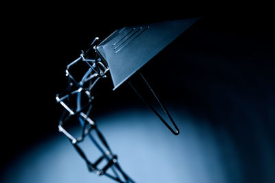 Close-up of electric lamp against black background