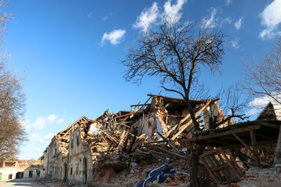 Low angle view of abandoned building against sky