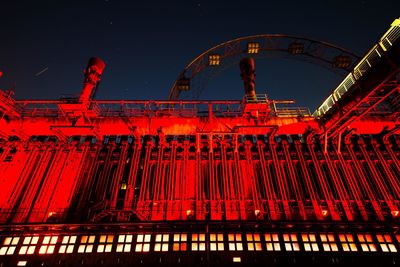 Low angle view of illuminated ferris wheel at night