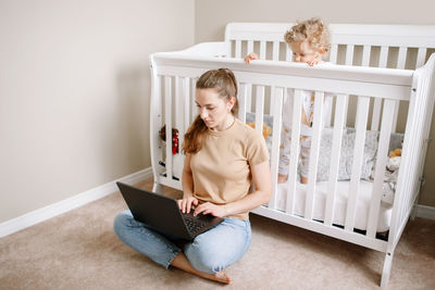 Woman using mobile phone at home