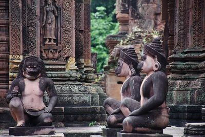 Statue of buddha against building