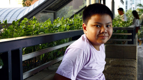 Portrait of boy standing in yard