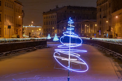 Illuminated city street at night