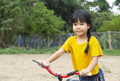 Portrait of a little girl riding bicycle