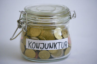 Close-up of coins in glass jar