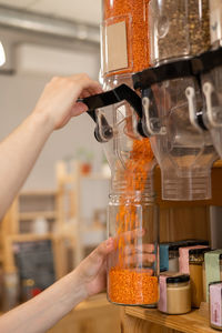 Cropped hand of person pouring in glass