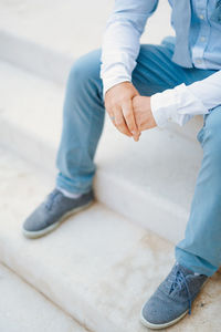 Low section of man sitting on floor