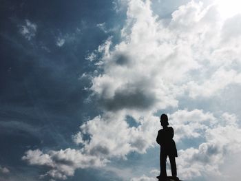 Full length of a boy against cloudy sky