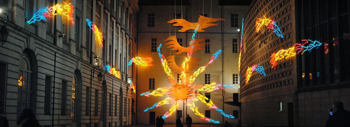 Low angle view of illuminated lanterns hanging at night