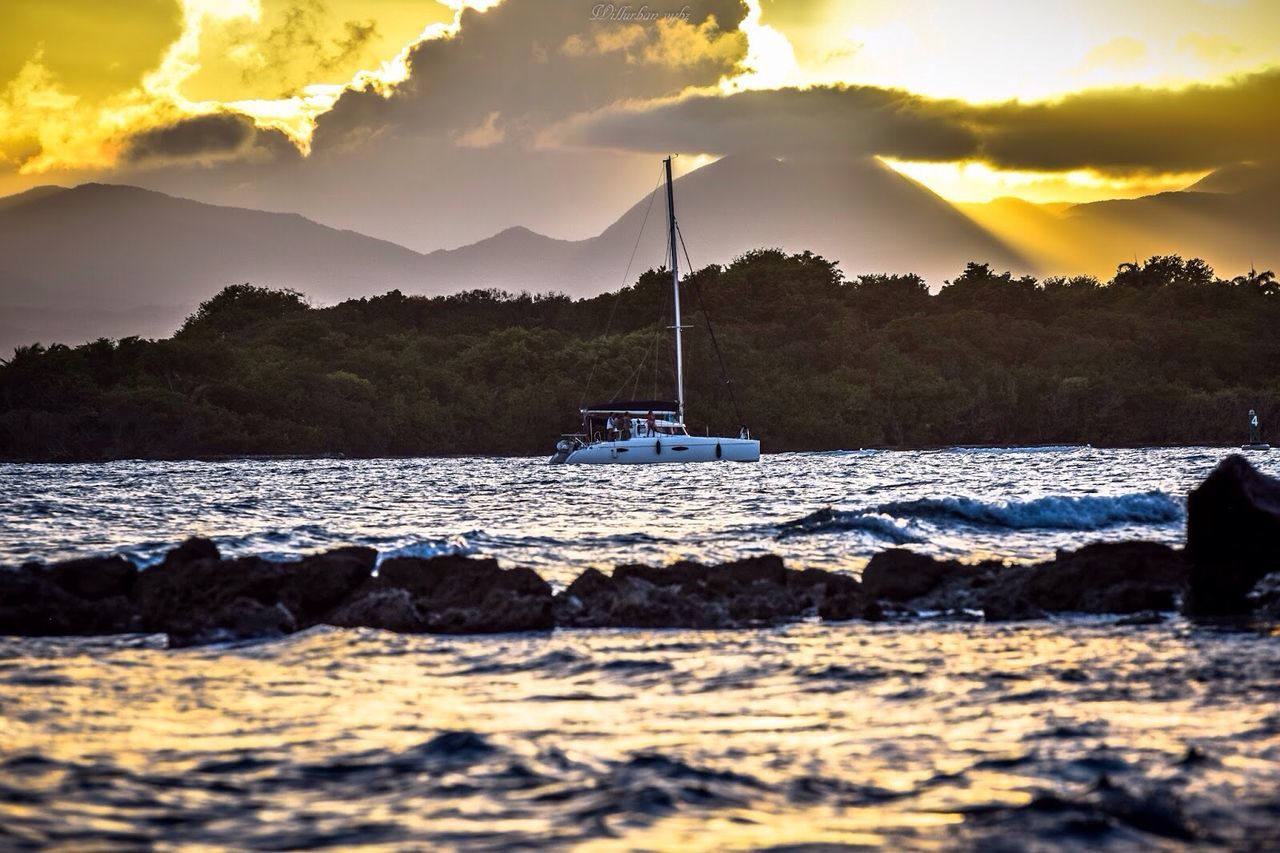 water, sunset, sky, sea, nautical vessel, scenics, beauty in nature, tranquil scene, tranquility, mountain, cloud - sky, waterfront, boat, nature, silhouette, transportation, idyllic, rock - object, mode of transport, rippled