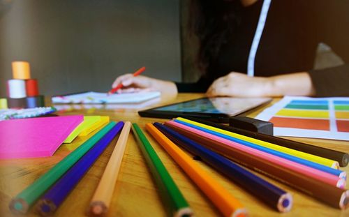 Close-up of multi colored pencils on table