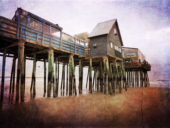 Low angle view of built structure on beach against sky