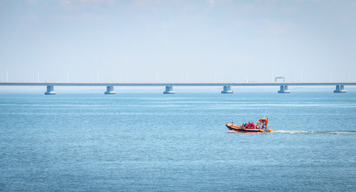 Sailboat sailing in sea against clear sky