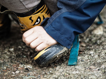 Close-up person wearing boot