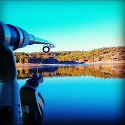 Scenic view of lake against clear blue sky