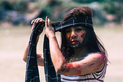 Young woman wearing headband during holi