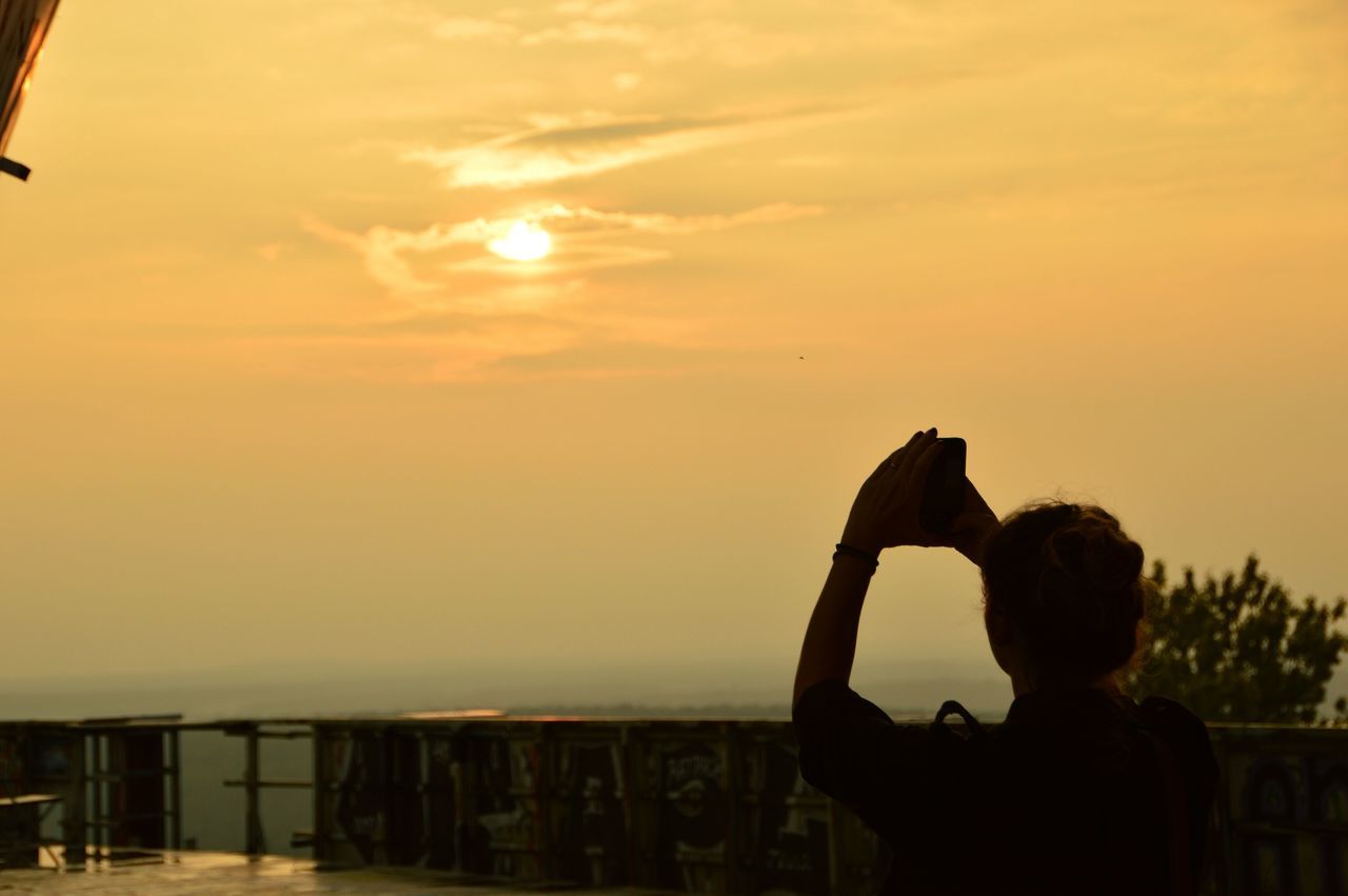 sunset, sky, silhouette, sea, water, cloud - sky, sun, orange color, scenics, beauty in nature, horizon over water, tranquility, railing, built structure, nature, tranquil scene, cloud, standing