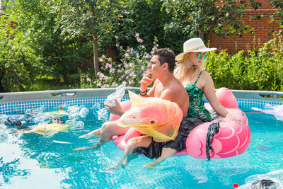 Woman sitting in swimming pool