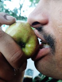 Close-up of man holding fruit
