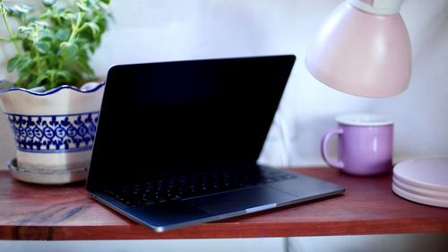 Close-up of laptop on table at home