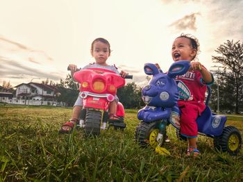 Full length of father and daughter on field against sky