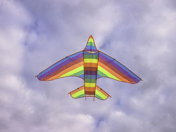 Low angle view of multi color kite flying against sky