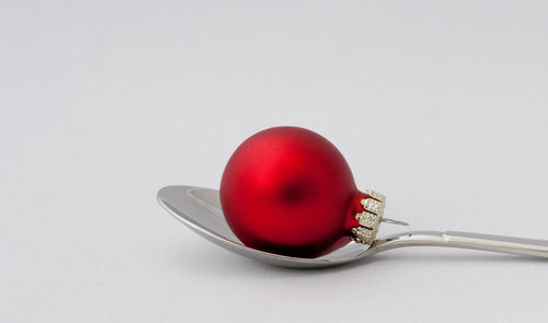 Close-up of tomatoes in plate against white background