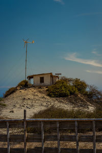 Built structure on field by building against sky