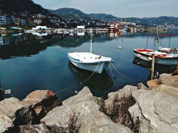 Boats moored on lake in town