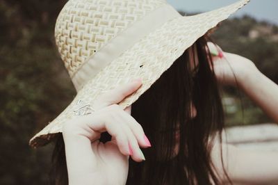 Close-up of woman wearing sun hat