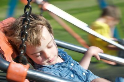 Portrait of boy holding slide in playground