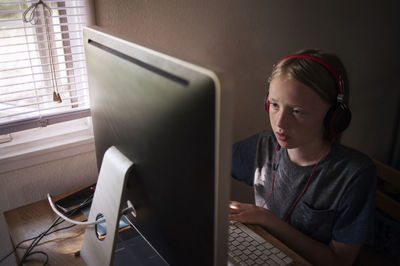 Boy using computer at desk