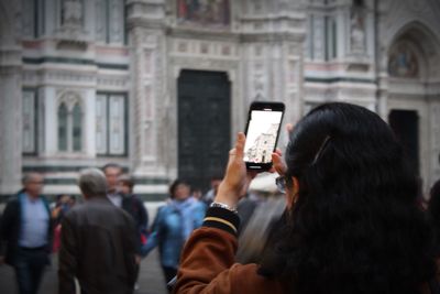 Rear view of woman photographing