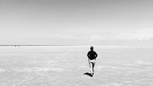 Full length of man skateboarding on sea against sky