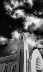 Low angle view of building against cloudy sky