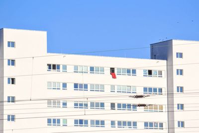 Low angle view of buildings against clear blue sky