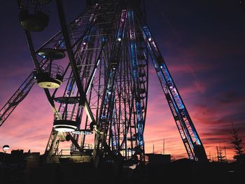 Low angle view of illuminated ferris wheel at night