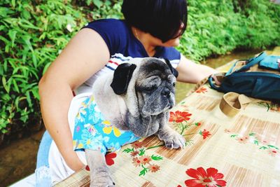 Woman holding dog on table