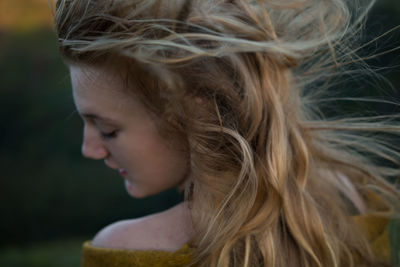 Close-up side view of a young woman