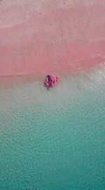 Aerial view of people relaxing in pool raft at sea