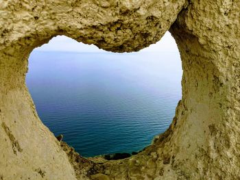 Scenic view of sea seen through cave