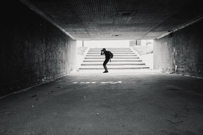 Side view of man photographing in tunnel