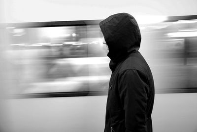 Side view of a man standing in bus