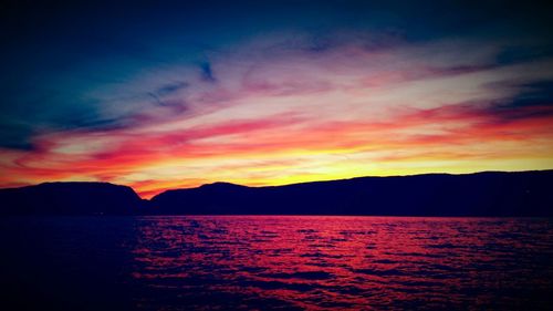 Scenic view of dramatic sky over sea during sunset